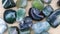 Moss agate heap up jewel stones texture on light varnished wood background. Moving right seamless loop backdrop