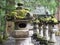 Moss Covered Stone Statues in a pebble garden