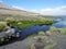 Mossy beach on the background of mountains under blue sky