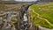 Mossy ravine with puddles of water construction site in volcanic rock