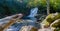 Mossy sunlit stones with a view of a flowing waterfall behind in Xico, Verecruz, Mexico