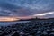 The most beautiful sunrise at Dunstanburgh Castle with the famous slippery black boulders in Northumberland, as the sky erupted wi