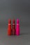 Most classic lipsticks colours dark red, bright pink and vivid red on a dark grey background