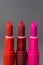 Most classic lipsticks colours dark red, bright pink and vivid red on a dark grey background