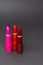 Most classic lipsticks colours dark red, bright pink and vivid red on a dark grey background
