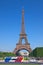 The most famous tower in the world. Eiffel Tower against the blue sky. Paris Open Tour is a touristic bus service