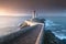 Most popular lighthouse in Europe during stormy weather. Petit Minou Lighthouse at sunset with red light, Brest , France