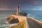 Most popular lighthouse in Europe during stormy weather. Petit Minou Lighthouse at sunset with red light, Brest , France