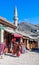 Mostar old town street with shops and historic architecture.