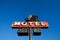 Motel sign against blue sky