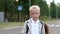 Mother adjusts her son`s clothes before school. Portrait of a child in a jacket