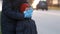 Mother adjusts the protective medical mask for her young son on the street of a European city. Protection against Chinese