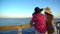 Mother and adult daughter admiring sea landscape and having fun on pier. View of Tiran island in Egypt