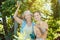 Mother and adult daughter checking apples in tree