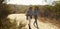 Mother And Adult Daughter Hiking Outdoors In Countryside