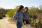 Mother And Adult Daughter Hiking Outdoors In Countryside