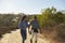 Mother And Adult Daughter Hiking Outdoors In Countryside