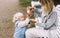 Mother applies sanitizer on her little son`s hands.