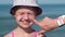 Mother apply protective sunscreen on daughter nose at beach on summer vacation