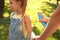 Mother applying insect repellent onto girl`s hand in park, closeup