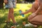 Mother applying insect repellent onto girl`s leg in park, closeup