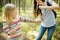 Mother applying insect repellent to her daughter before forest hike summer day. Protecting children from biting insects at summer