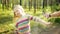 Mother applying insect repellent to her daughter before forest hike summer day. Protecting children from biting insects at summer