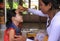 Mother applying makeup on girl`s face before dance