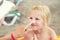 Mother applying sunscreen protection creme on cute little daughter face. Mom using sunblocking lotion to protect kid girl from sun