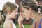 Mother Applying Sunscreen To Girl\'s Nose