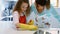 Mother assisting daughter in cleaning kitchen