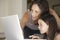 Mother Assisting Daughter In Using Laptop