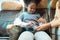 mother assists her youngster in fastening his seatbelt to keep him safe during a flight