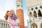 Mother and baby against campanile di san marco