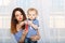 Mother and baby daughter inflate soap bubbles