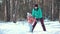 Mother and baby girl daughter playing and laughing in winter outdoors in the snow