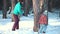 Mother and baby girl daughter playing and laughing in winter outdoors in the snow