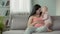 Mother and baby girl nuzzling tenderly with smiles on faces, sweet maternity