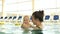 Mother and baby have fun in the pool. A woman kisses and hugs her child. Mothers Day