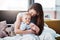 Mother, baby and hug in bed with love or bedroom, peace in morning and newborn together, relax and calm mom in home