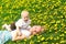 Mother and Baby Laying in Dandelions