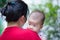 Mother and baby, Lovely asian girl resting on her mother\'s shoul