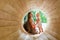 Mother and baby playing on the Playground in the wooden tunnel. Eco-friendly natural playground