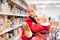 Mother with baby shopping in supermarket