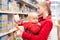 Mother with baby shopping in supermarket