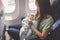 Mother and baby sitting together in airplane