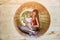 Mother and baby sitting in wooden tunnel. Eco-friendly playground. Soft light