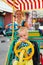 Mother with baby son have fun, riding on rental quadricycle