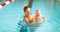 Mother and baby swim in pool