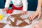 Mother and baby together cut out cookies from the dough. Top view. Close up. Christmas concept and family cooking meals with